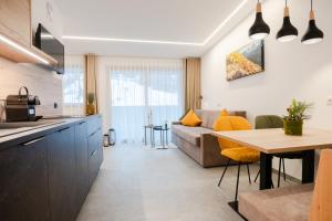 a kitchen and living room with a couch and a table at Residence Katrin in San Valentino alla Muta