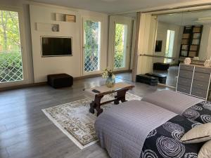 a bedroom with a bed and a table and a tv at La tua casa con giardino a 2 passi dal centro in Modena