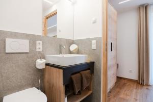 a bathroom with a sink and a toilet at Residence Katrin in San Valentino alla Muta +21 photos