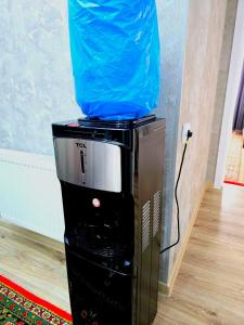 a blue bag sitting on top of a microwave at Golden house deluxe 2 in Bukhara