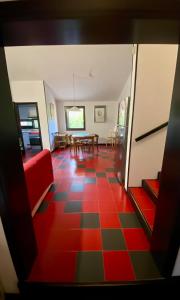 a living room with a red couch and a table at Exclusive Sardinian Villa 300 mt from the beach in Àrbatax +22 photos