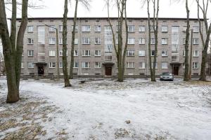 a large building with snow in front of it at Airport Apartment in Tallinn