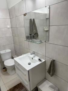 a white bathroom with a sink and a toilet at COMME un POISSON in Sainte-Anne +35 photos