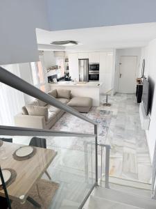 a living room with a couch and a table at Duplex Penthouse with Seaview. in Benalmádena