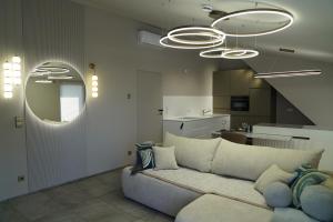 a living room with a couch and a kitchen at Kleine Studio-Wohnung, kontaktloser Check-in in Meckenbeuren