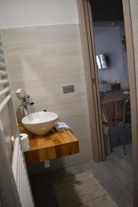 a bathroom with a bowl sink on a wooden counter at CASA della GIOIA in Caltagirone +73 photos