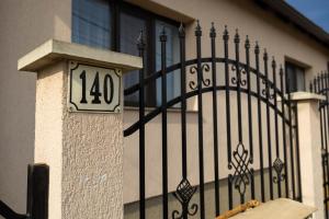 a house with a clock on the side of a fence at Casa Vultur in Sighişoara