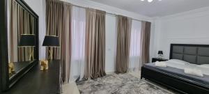 a bedroom with a large bed and a large mirror at Studio 1 in Târgu Neamț +7 photos