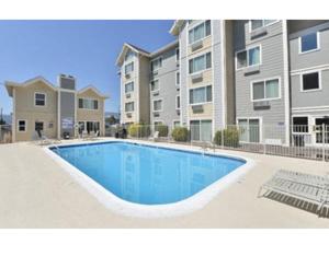 a swimming pool in front of a apartment building at The Rivet in Reno