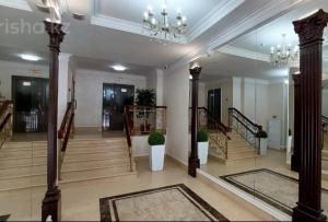 a large lobby with stairs and a chandelier at ЖК Edel 1ком квартира комфорт набережная проспект Сарыарка in Astana