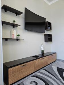 a living room with a flat screen tv on a wall at ЖК Edel 1ком квартира комфорт набережная проспект Сарыарка in Astana