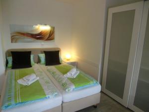 a bedroom with a bed with two towels on it at Villa Vogelsang VV, Schwimmbad, Sauna in Sierksdorf +16 photos