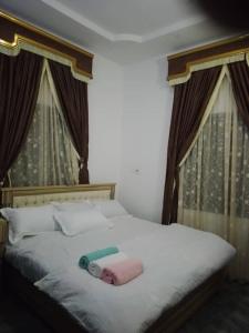 a bedroom with a bed with a towel on it at Stylishly in Rubuchi