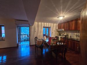 a kitchen with a table and chairs in a room at Cleopatrahouse in Stemnitsa