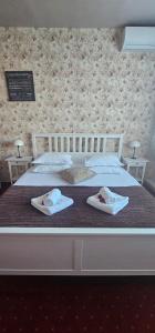 Voodi või voodid majutusasutuse Hotel Olimp toas