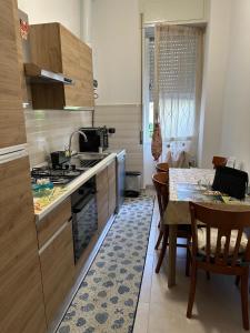 a kitchen with a table and a stove top oven at Giusi home in Cologno Monzese