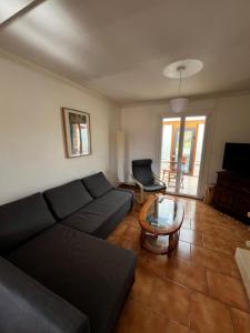 a living room with a couch and a table at Maison Langres 6 personnes in Langres