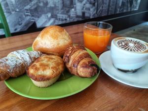 a plate of food with pastries and a cup of coffee at Affittacamere Li Manca in Surbo