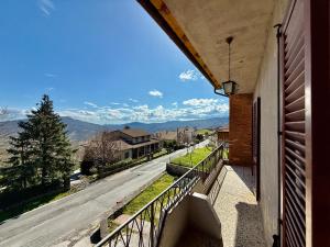 a balcony with a view of a street and mountains at Sosta FONTE DAVIDDI in Santa Fiora