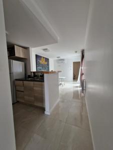 a white kitchen with a counter in a room at Agradable departamento in Cordoba