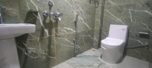 a bathroom with a toilet and a sink at Hillcrest Prapti Homestay in Darjeeling