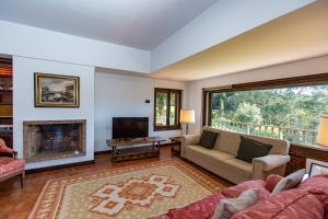 a living room with a couch and a fireplace at Finca Tolombreo Casa Gabriel in Cudillero