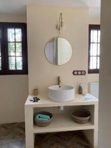 a white bathroom with a sink and a mirror at Villa Artemis in Roda de Bará +11 photos
