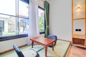 Postel nebo postele na pokoji v ubytování Collection O Samurai Hotel