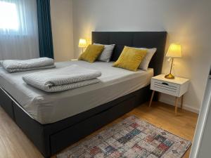 a bedroom with a large bed with yellow pillows at Apartman PEPI LUXURY in Novi Zagreb