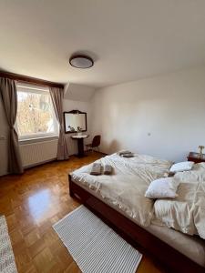a bedroom with a large bed and a window at Oaza Narave in Spodnje Gorje +26 photos