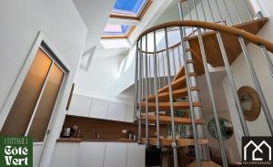 a spiral stairway in a building with a staircase at Les Inattendus - Cottages Premium, Proche Mer avec Parking privé in Boulogne-sur-Mer