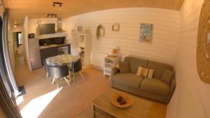a small living room with a couch and a table at Eco-lodges Lacanau Moutchic Inn - 4 pers in Lacanau