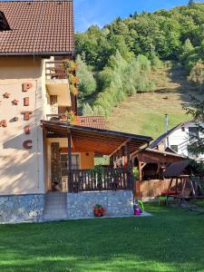 a house with a porch and a balcony at Pensiunea Pitic in Cheia