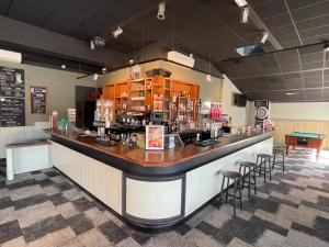 a bar in a restaurant with stools at Mobil home 3 chambres, empl K079, les charmettes in Les Mathes