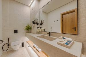 a bathroom with a sink and a toilet and a mirror at Desert Rose Resort in Hurghada