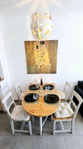 a dining room table with chairs and a chandelier at HDFM Collection - Sea Garden in Playa del Ingles +34 photos