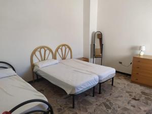 Ένα ή περισσότερα κρεβάτια σε δωμάτιο στο appartamento torre lapillo