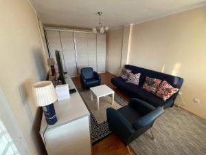 a living room with a couch and a chair at Comfort & Style Panoramic Urban Retreat 2 in Belgrade