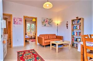 a living room with a couch and a table at Ferienhaus Nora mit zwei schönen Doppelhaushälften, "Meeresbrise 1" in Agios Spyridon Corfu