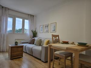 a living room with a couch and a table at Brisa Marina in Mogro