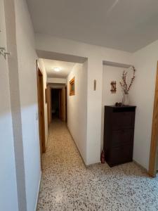 an empty hallway with a dresser in a room at La Turia Soleada in Cullera