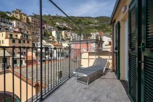 a balcony with a bench on top of a building at Locus Amoenus in Riomaggiore
