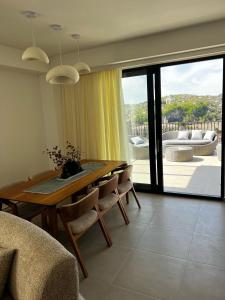 a living room with a wooden table and chairs at Rioni & Bagrati Panorama in Kutaisi