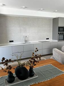 a living room with a table and a kitchen at Rioni & Bagrati Panorama in Kutaisi