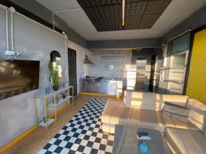 a living room with a couch and a checkered floor at jim villa1 family apartment fast wi-fi free parking in Kyllini