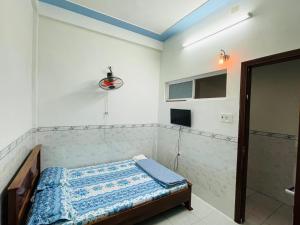 Cette petite chambre comprend un lit et une douche. dans l'établissement Nhà Nghỉ Hải Đăng, à Quy Nhơn 5 autres photos