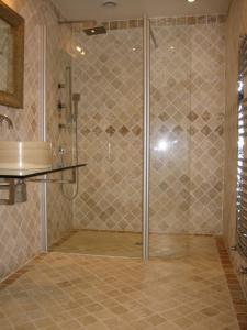 a shower with a glass door in a bathroom at Villa - La chambre des Dames in Vallères