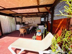 a patio with a white bench and a table at Ático Sol Vecindario in Vecindario