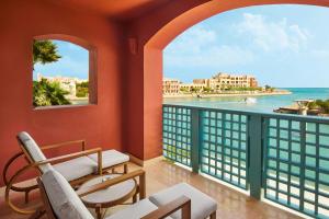 a balcony with chairs and a view of the ocean at Sheraton Miramar Resort El Gouna in Hurghada