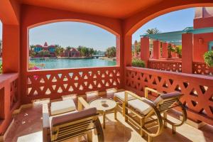 a porch with chairs and tables and a view of the water at Sheraton Miramar Resort El Gouna in Hurghada
